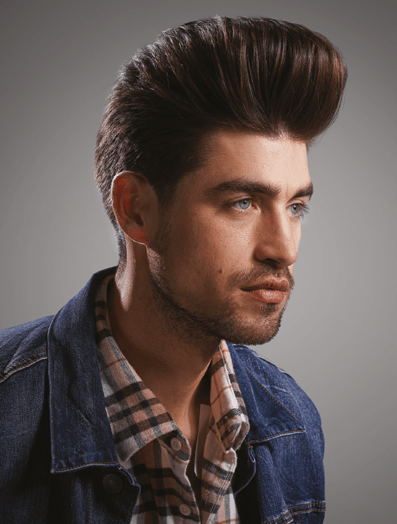 Man with a pompadour haircut dressed in a denim jacket looking to the right