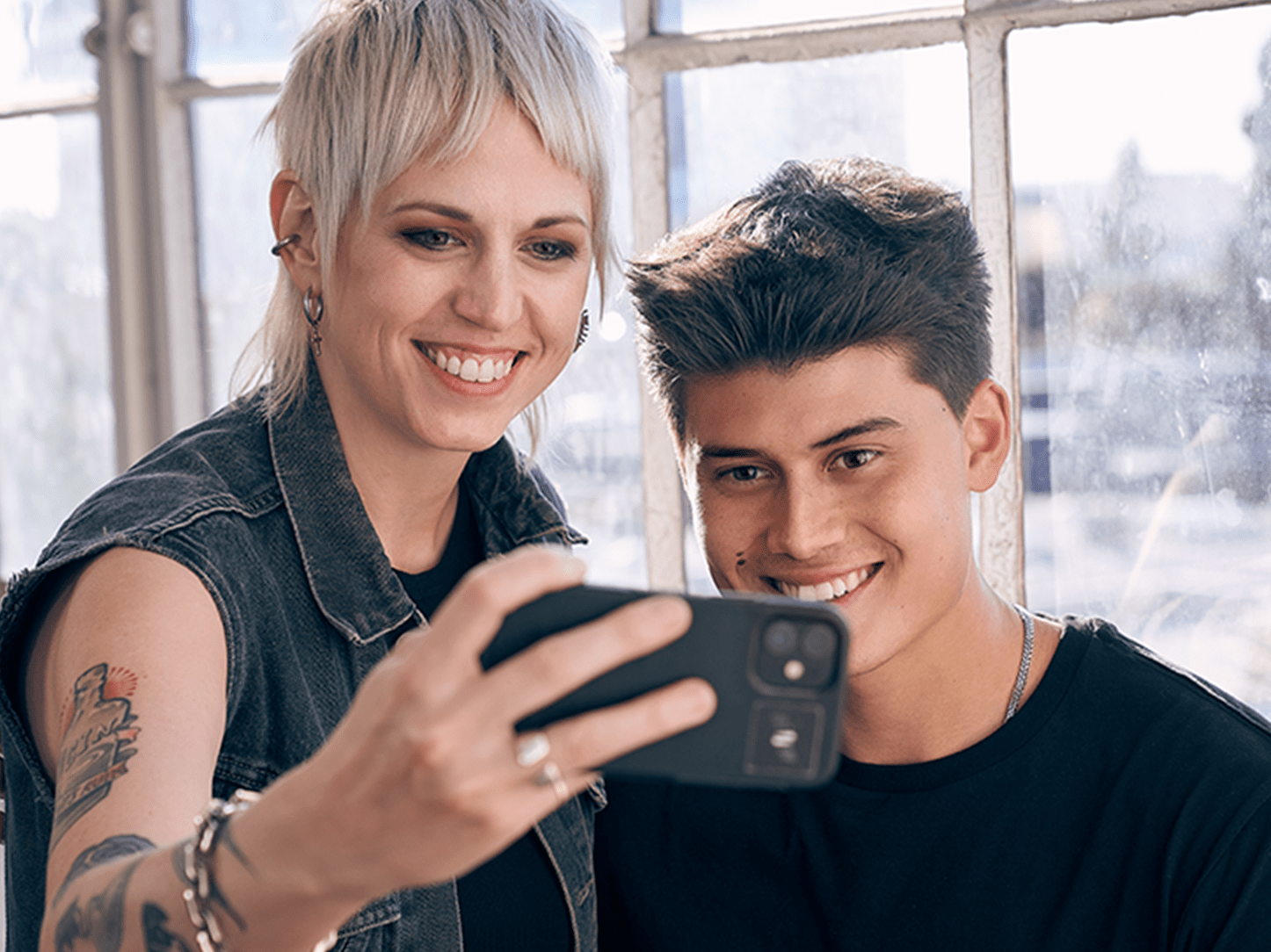 Barber posing with a model taking a selfie