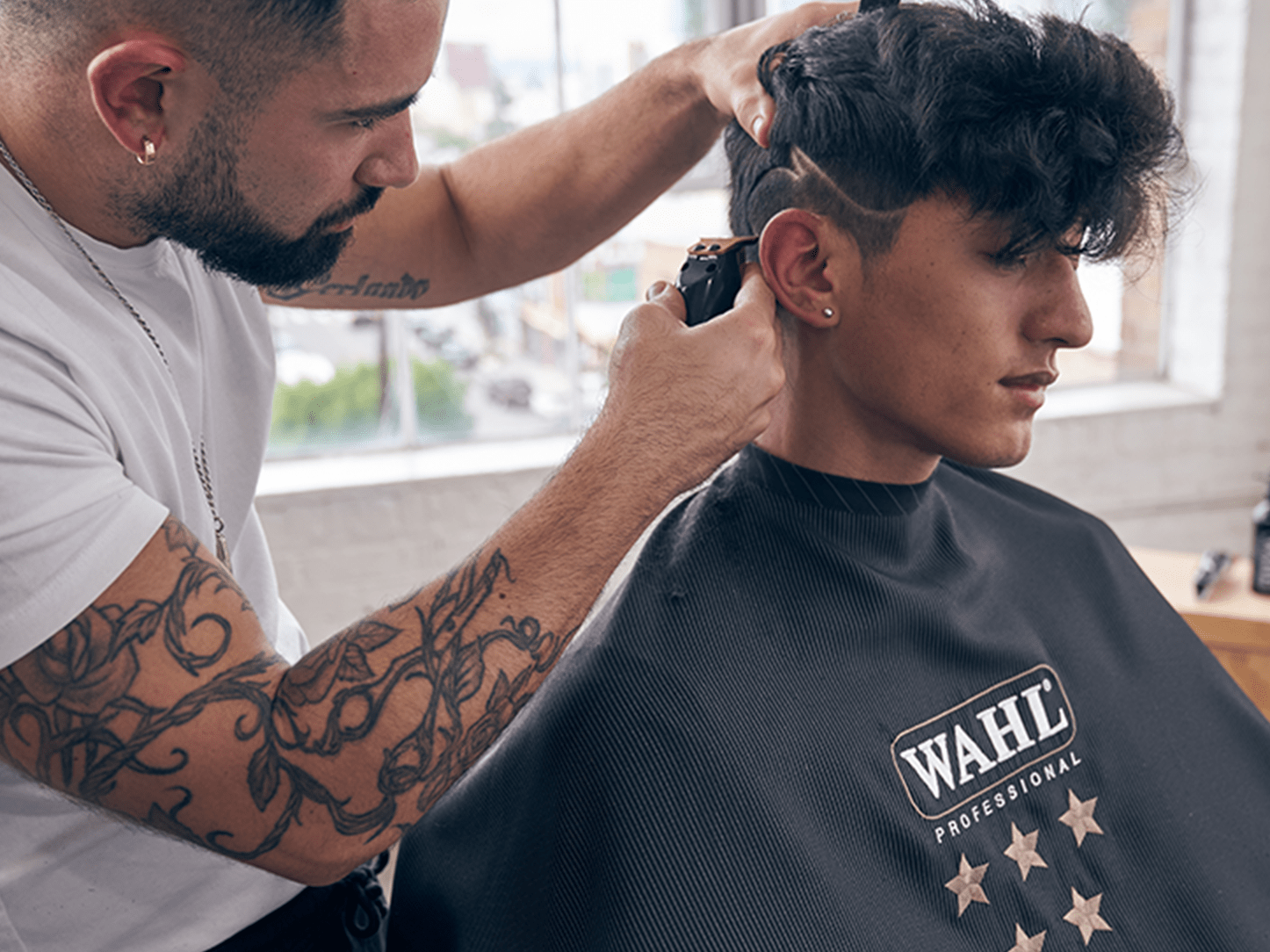 Barber cutting a design into hair with a Wahl Gold Detailer LI trimmer