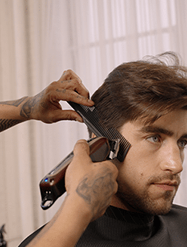 Barber using Wahl Cordless Legend clipper to cut hair into pompadour cut